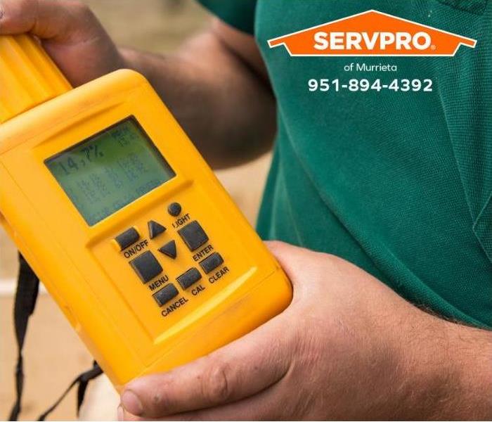 A hygrometer moisture meter is being used.