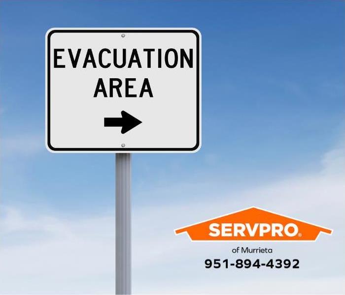 A sign points the way to an evacuation area.