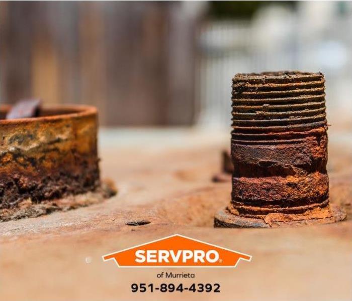 The corroded parts of a failed water heater are shown.