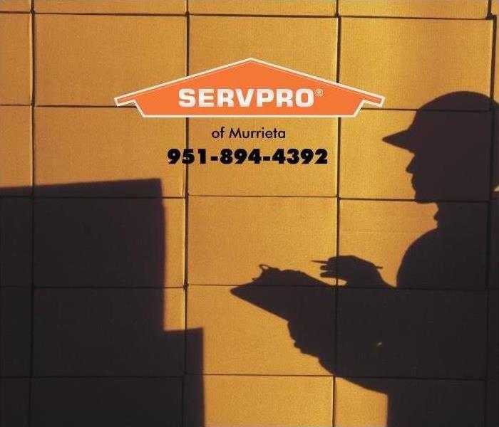 shadow of a delivery person on a stack of boxes