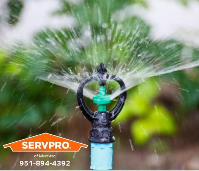 A sprinkler system is watering a lawn.