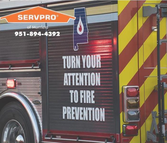 Turn your attention to fire prevention written on the side of a fire truck.