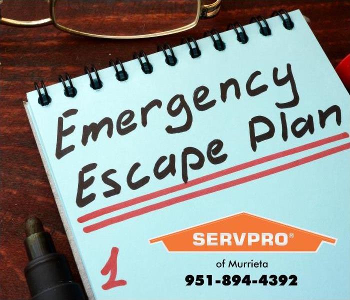 A pen sits next to a pad of paper with “Emergency Escape Plan” written on top